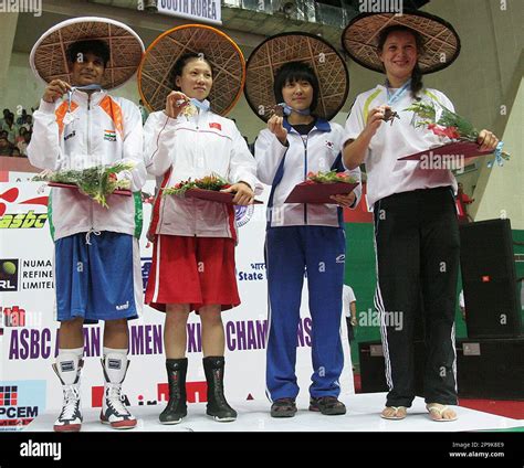 Left to right, India's Pavitra (silver medal), China's Zhang Qin (gold ...