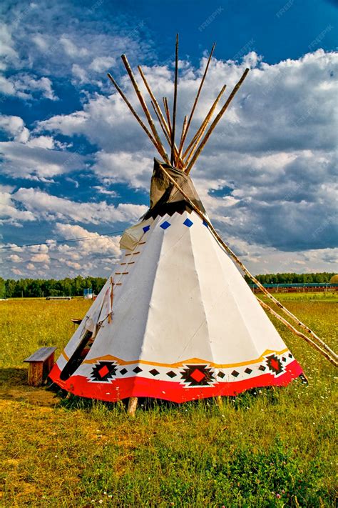 Premium Photo | An indian teepee set up in a meadow among pine woods ...