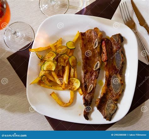 Traditional Spanish Dish is Churasco with French Fries and Zucchini ...