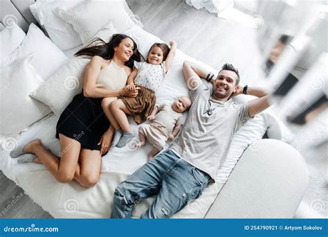 Young Parents and Their Children Lie in Bed Top View Stock Image - Image of little, emotion ...