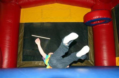 A child plays in a bouncy house during a Jump-N-Jax Pot Luck held for ...