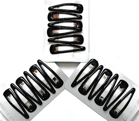 Black hair/snap clips. In a set of 18 ( 3 packs of 6).