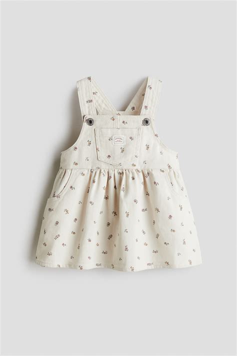 Cotton twill dungaree dress - Cream/Floral - Kids | H&M IN