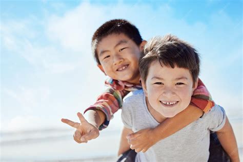 Beach peace sign and asian children hug on japan travel vacation for ...