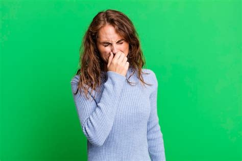 Premium Photo | Feeling disgusted holding nose to avoid smelling a foul ...