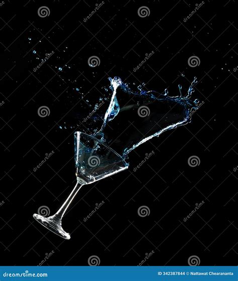 Pouring Clear Cocktail Glass with Spilled Blue Liquid in Air. Blue Soda ...