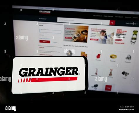 Person holding mobile phone with logo of US industrial supply company W ...