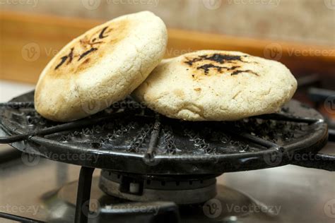 Stuffed Colombian arepa preparation. Colombian arepas being roasted on ...