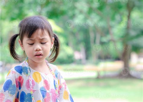 Headshot of sad 4 years old cute baby Asian girl, little toddler child ...