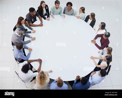 Business people having a meeting at round table Stock Photo - Alamy