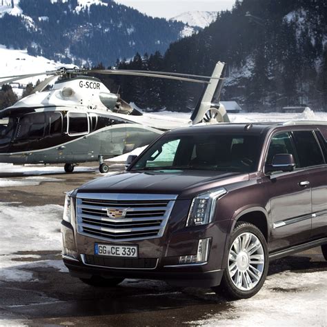 Download Sleek Luxury Cadillac Escalade on the Open Road Wallpaper | Wallpapers.com