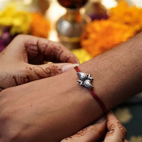 Handcrafted Silver Rakhi/Pendant: Koyari with Petals | House of Aadyaa