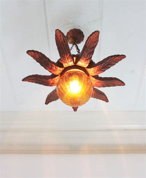 Spanish Colonial Sunburst Light Fixture in Carved Wood with Amber Glass ...