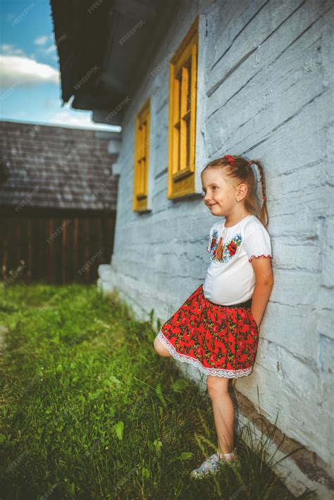 Premium Photo | Happy small four years old girl dressed in red folk skirt posing in traditional ...