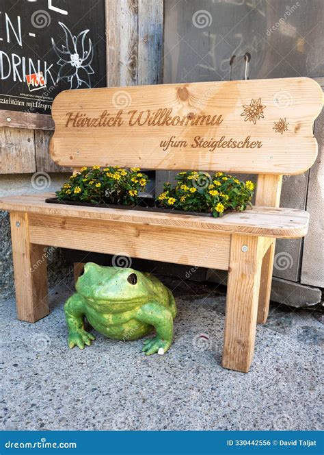 Rustic Bench with WELCOME German Sign, Frog Figure Editorial Photo ...