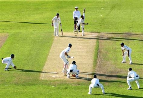 Fielders surround Chris Tremlett during the final overs of the first ...