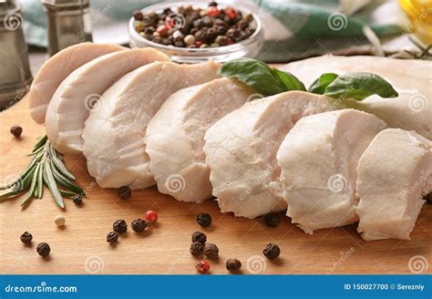 Sliced Boiled Chicken Fillet with Herbs and Spices on Wooden Board ...