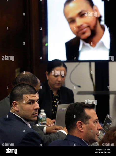 Former New England Patriots tight end Aaron Hernandez, left, sits in ...