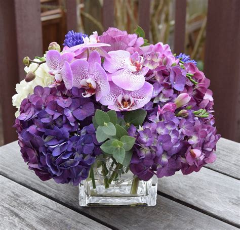 Flower arrangement with purple hydrangeas, cymbidium orchids and ...