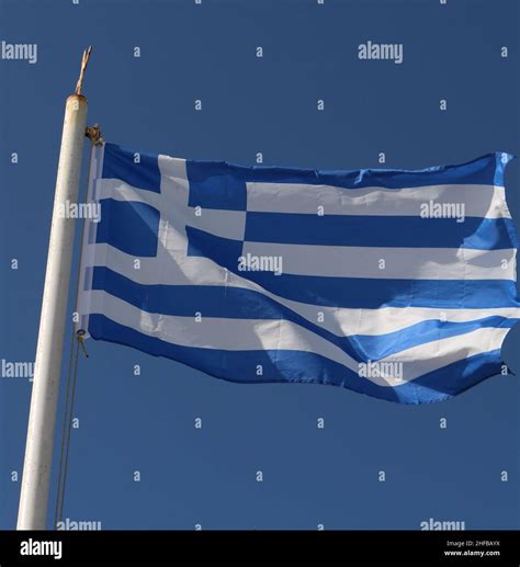 Flag of Greece flying, Greek flag flying Stock Photo - Alamy