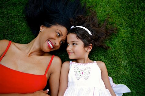 Mother laying in the grass with her biracial daughter | Wood County JFS