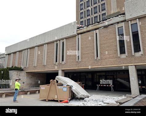 A worker on the campus of UW-Madison surveys the scene of a partial ...