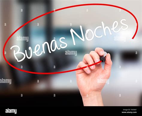 Man Hand writing Buenas Noches (Good Night In Spanish) with black marker on visual screen Stock ...