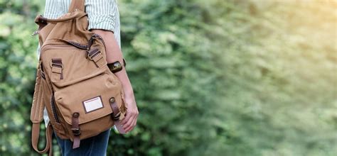 Backpack traveler closeup over green tree nature background | Premium Photo