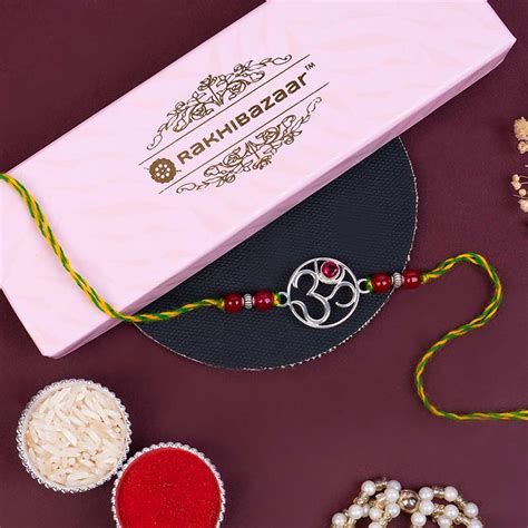 Send Pure Silver 925 Sterling Om Rakhi with Roli Chawal Online - RKH23 ...