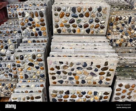 A pile of concrete tiles filled with rocks on top Stock Photo - Alamy