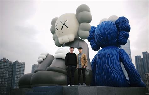 Artist KAWS Reveals the Inspiration Behind His New Sculpture in ...