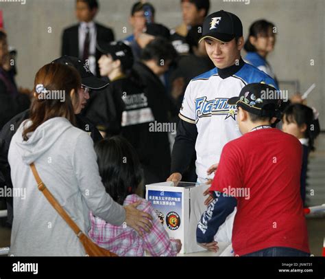 SAPPORO, Japan - Nippon Ham Fighters rookie Yuki Saito takes part in a ...