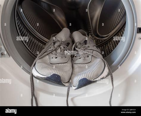 Sneakers inside the washing machine Stock Photo - Alamy
