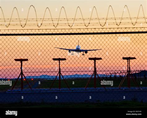 Commercial airline plane jet landing at Vancouver Airport YVR at sunset ...