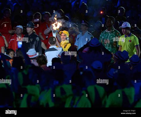 The torch enters the Coliseum at the conclusion of opening ceremonies ...