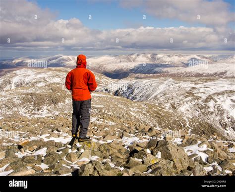 A walker on the summit of Scafell Pike, Lake district, UK, the highest ...