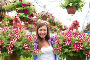 Happy and smiling female florist holding bouquet flower plant at ...
