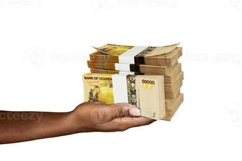 Hand Holding 3D rendering of stacks of Ugandan shilling notes isolated ...
