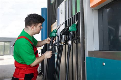 A Down syndrome man employee fueling car at gas station. photo – Car Image on Unsplash