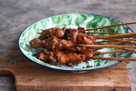 Sate or satay, skewered and grilled meat, served with chili sauce and ...
