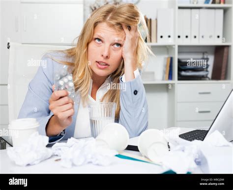 Exhausted of hard work business lady sitting in office among papers and ...