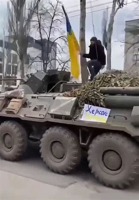 Watch Video: Ukrainian man climbs on top of Russian tank to wave ...