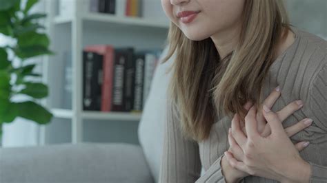 hand hold chest with heart attack symptoms, asian woman have chest pain caused by heart disease ...
