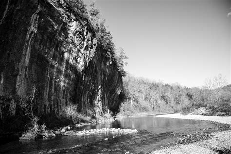 Monochrome photo of current river and cliff at Echo Bluff State Park ...