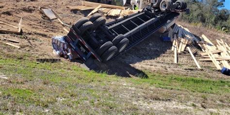 Semi-truck hauling lumber flips in Levy County on U.S. 27
