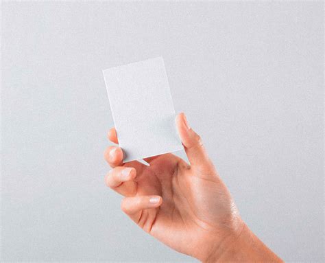 Free Hand Holding Vertical Business Card Mockup (PSD)