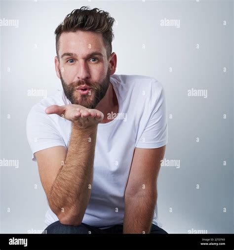 Young man blowing kiss hi-res stock photography and images - Alamy