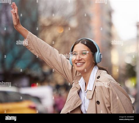 Just me and the big city. a beautiful young woman trying to hail a cab ...