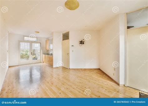 A Living Room with White Walls and a Wood Floor Stock Photo - Image of ...