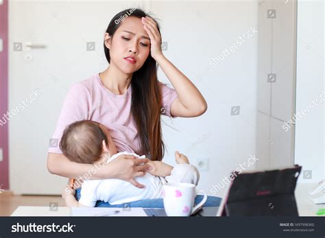 Stressed Mother Breastfeeding Her Newborn Baby Stock Photo 1697998360 ...